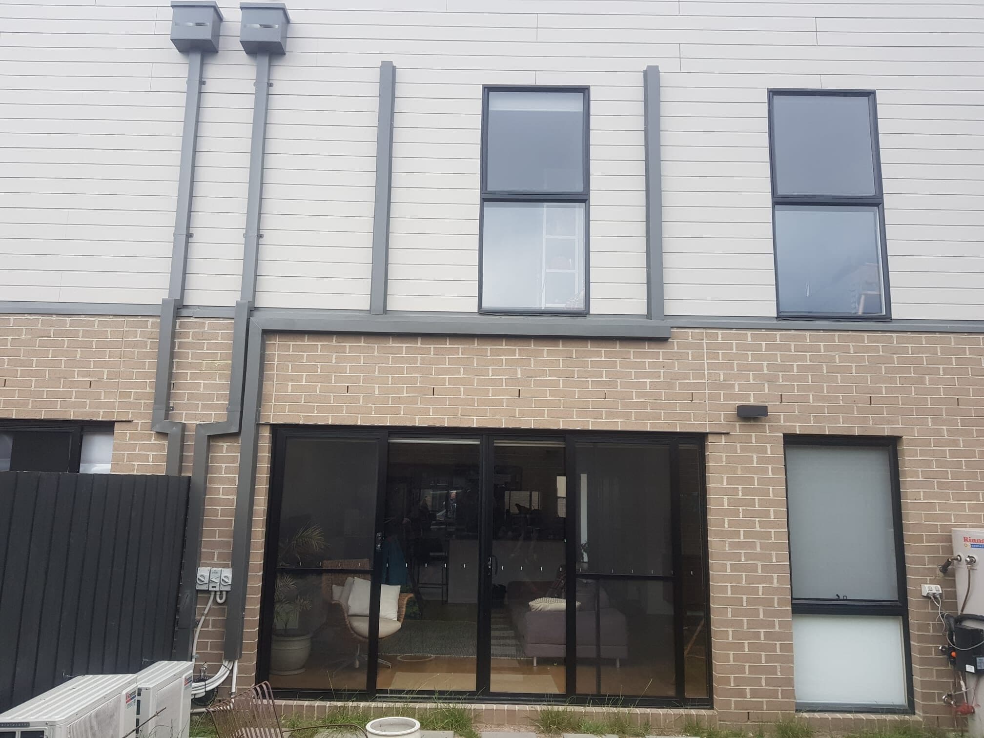 External capping runs carried cleanly down the cladding and brickwork of a two-storey townhouse facade in Avondale Heights