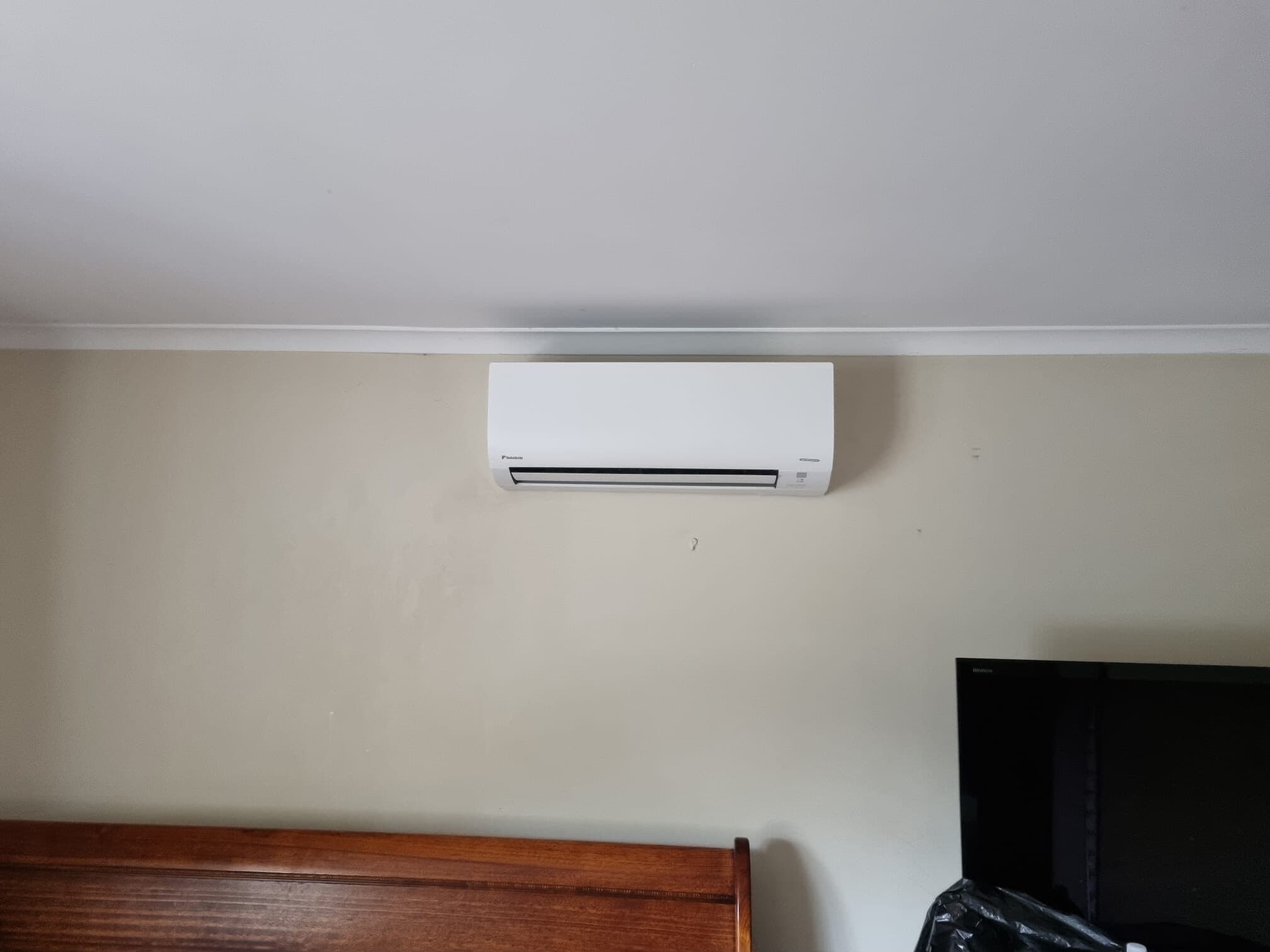 A wall-mounted split-system head installed just under the cornice in Keilor East