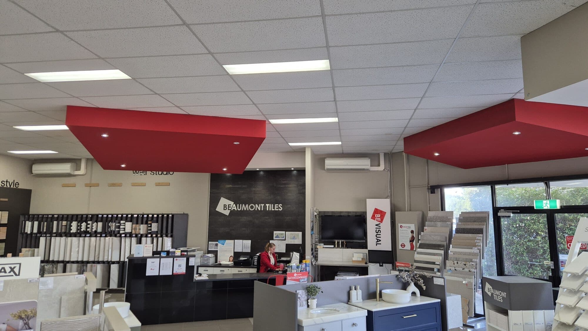A wall-mounted split-system head in the Beaumont Tiles showroom in Narre Warren, branded fit-out around it