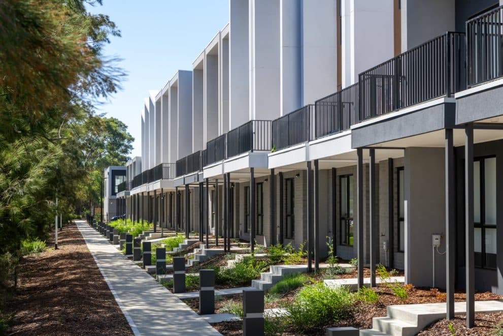 Row of completed Melbourne townhouses with landscaped frontage, fitted out by Climate Group