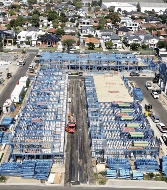 Aerial view of the Wattle House construction site in Maidstone, blue steel framing laid out across the medium density development