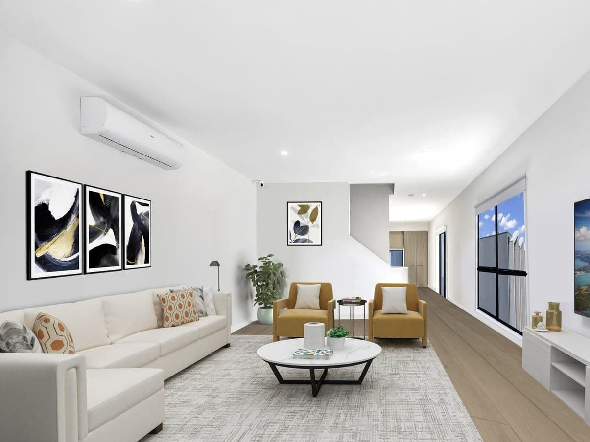 Wall-mounted split-system head in the living area of a townhome at the Belmont Collection in Mill Park